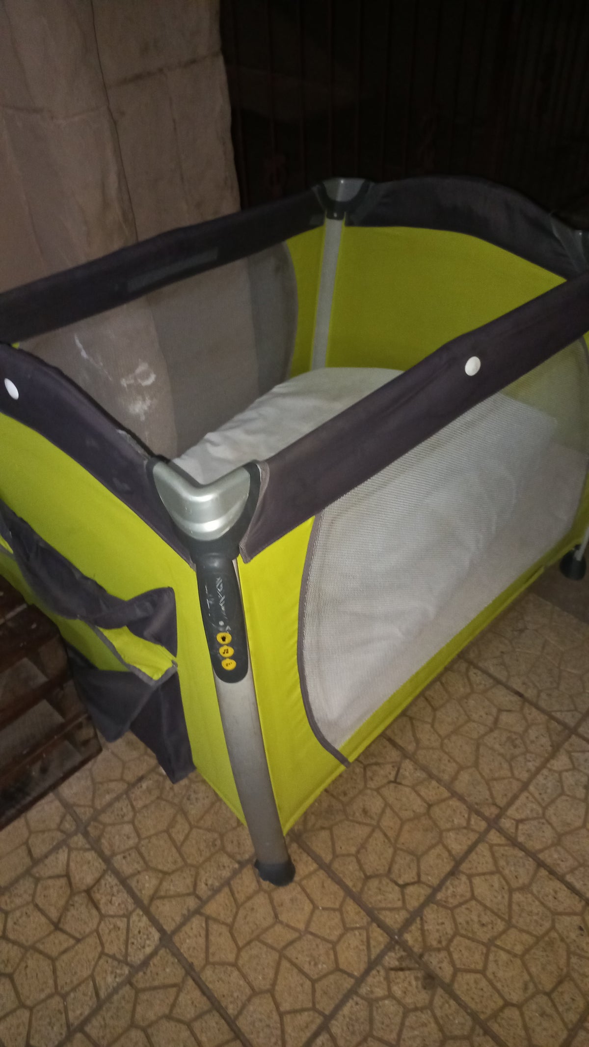 Joie lime green and grey foldable baby travel cot with mesh sides and padded mat