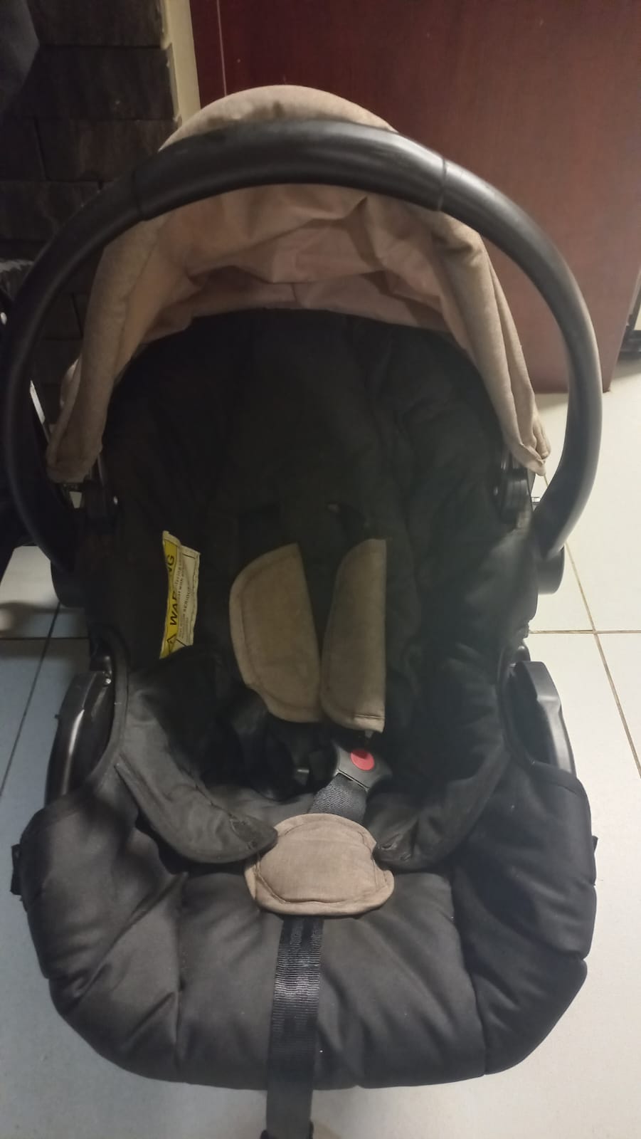 Baby infant car seat in black and beige with canopy and 5-point harness
